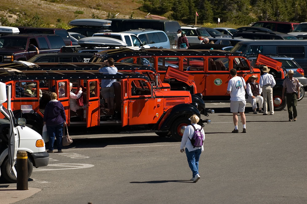 Logan Pass Parking Lot The parking lot at the Logan Pass visitor center in Glacier National Park is often full, so try to get there early in the morning, or late in the afternoon. Or take a tour on one of the long red beautifully restored old Ford busses.